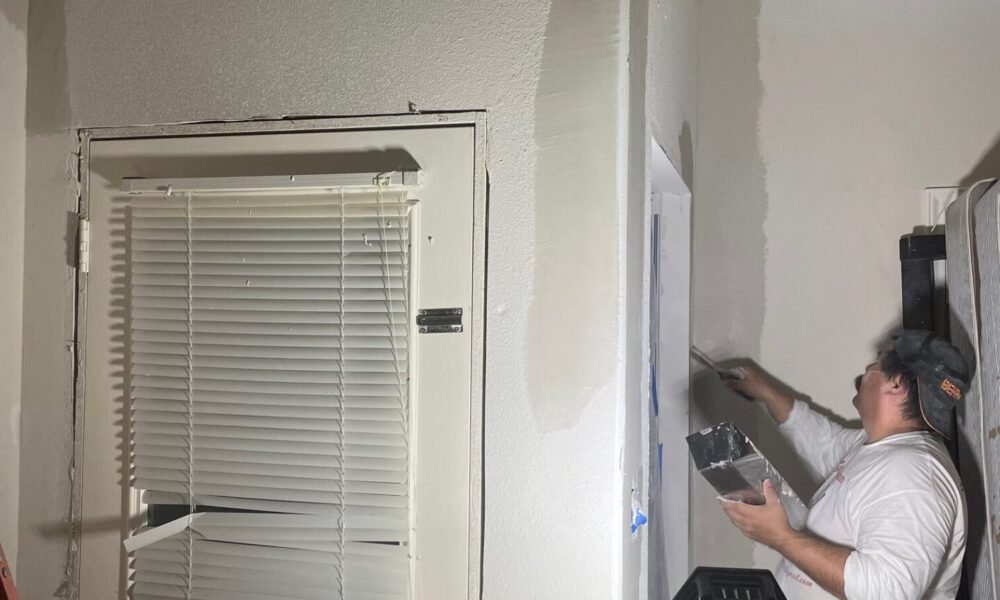 painting or working on a wall near a door Sugar Land