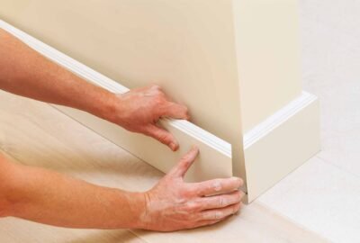 homeguide-worker-installing-interior-trim-baseboard